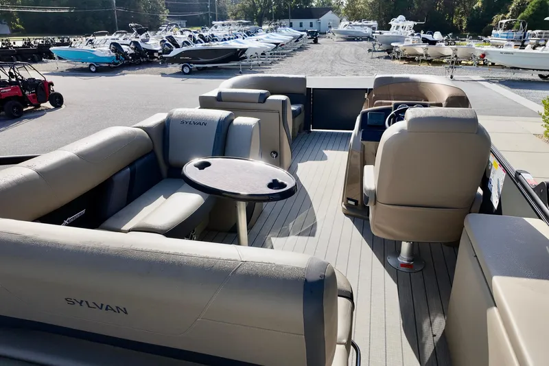 Slide: The Image of 2026 Sylvan Mirage X3 CLZ pontoon boat interior with seating and steering console. - 3