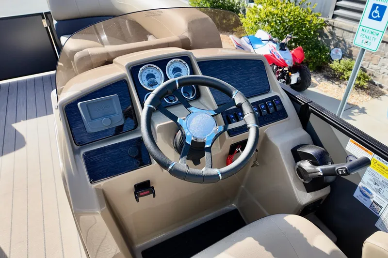 Slide: The Image of 2026 Sylvan Mirage X3 CLZ boat dashboard with steering wheel and control panel. - 6