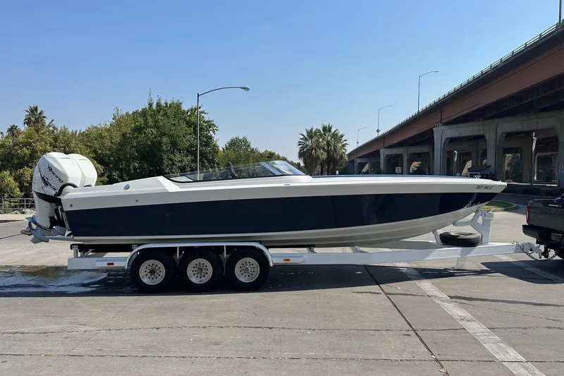 The Image of 2017 Formula 292 SR-1 boat on trailer near highway and trees. - 0