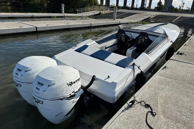 Slide: The Image of 2017 Formula 292 SR-1 speedboat docked with twin Mercury Racing 400 outboard engines. - 12