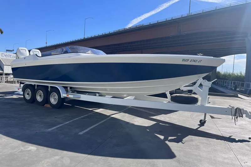 Slide: The Image of 2017 Formula 292 SR-1 boat on trailer under bridge, sunny day. - 2