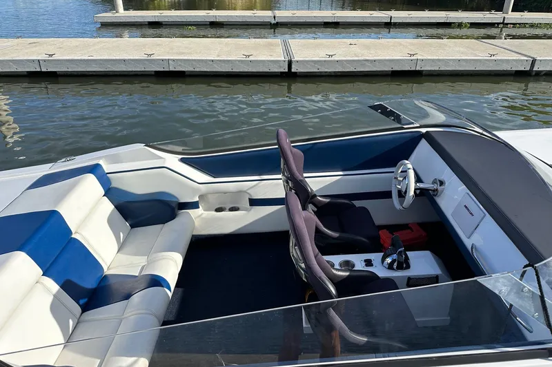 Slide: The Image of 2017 Formula 292 SR-1 boat interior with blue and white seating at a dock. - 20