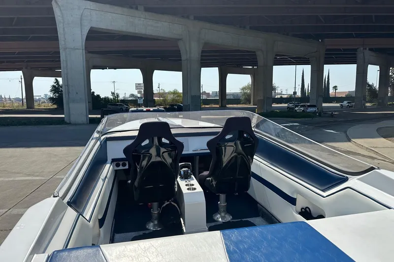 Slide: The Image of 2017 Formula 292 SR-1 boat interior under highway overpass, featuring two racing seats. - 22