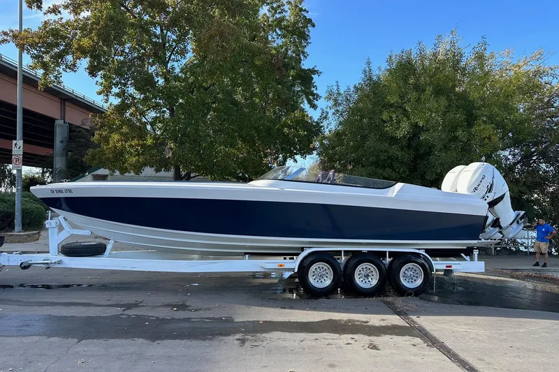 Slide: The Image of 2017 Formula 292 SR-1 boat on trailer, parked outdoors near trees. - 3