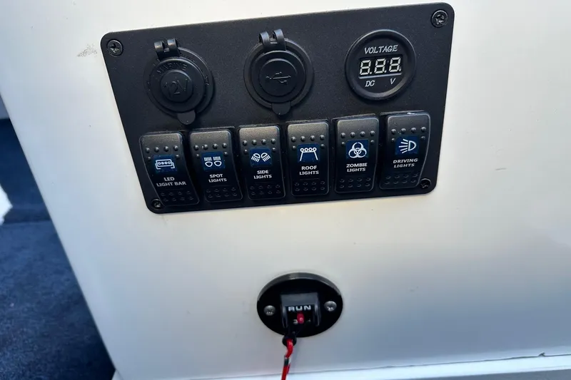 Slide: The Image of Control panel of a 2017 Formula 292 SR-1 with various light switches and voltage display. - 32