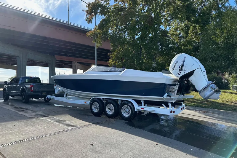 Slide: The Image of 2017 Formula 292 SR-1 boat on trailer, parked under bridge, with truck. - 5