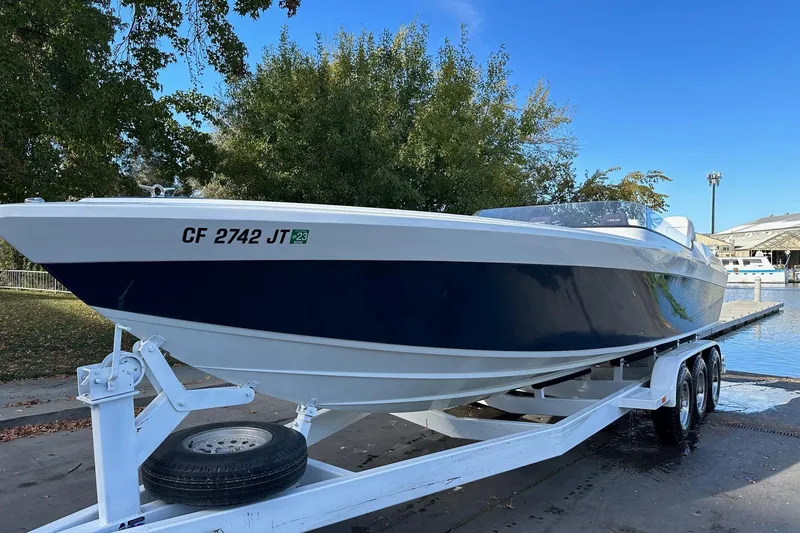 Slide: The Image of 2017 Formula 292 SR-1 boat on trailer, dockside, with trees and marina in background. - 8