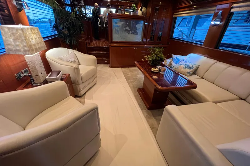 Slide: The Image of Luxurious 2012 Hampton motor yacht interior with elegant seating and wooden accents. - 13