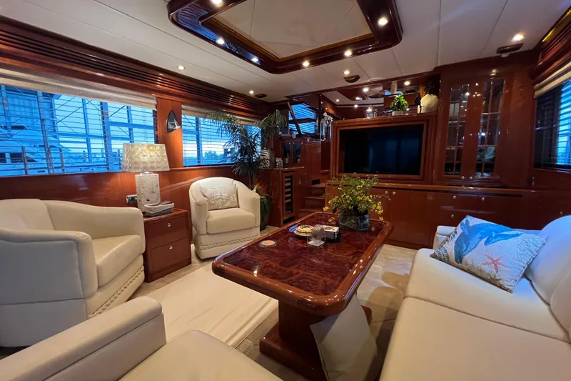 Slide: The Image of Luxurious 2012 Hampton motor yacht interior with elegant seating and wooden accents. - 17