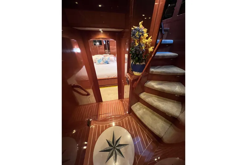 Slide: The Image of Luxurious 2012 Hampton motor yacht interior with elegant staircase and floral arrangement. - 20