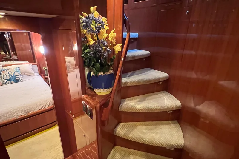 Slide: The Image of Luxurious 2012 Hampton motor yacht interior with elegant staircase and cozy bedroom. - 23