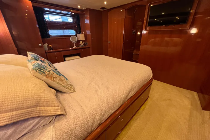 Slide: The Image of Luxurious bedroom interior of a 2012 Hampton motor yacht with elegant wood finishes. - 26