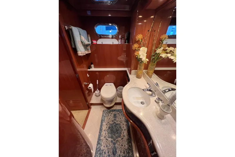 Slide: The Image of Luxurious 2012 Hampton motor yacht bathroom with elegant wood finish and floral decor. - 27