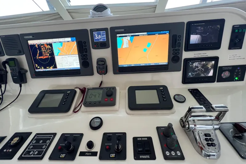 Slide: The Image of Control panel of a 2012 Hampton Motor Yacht with navigation and monitoring systems. - 35