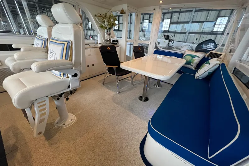 Slide: The Image of Luxurious 2012 Hampton motor yacht interior with white seating, blue cushions, and elegant dining area. - 36
