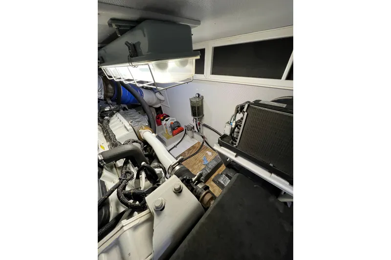 Slide: The Image of Engine room of 2012 Hampton motor yacht, showcasing mechanical components and lighting. - 46