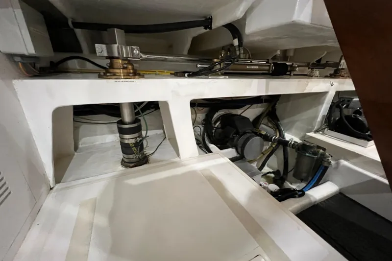 Slide: The Image of Engine room of 2012 Hampton motor yacht, showcasing mechanical components and hydraulic systems. - 47