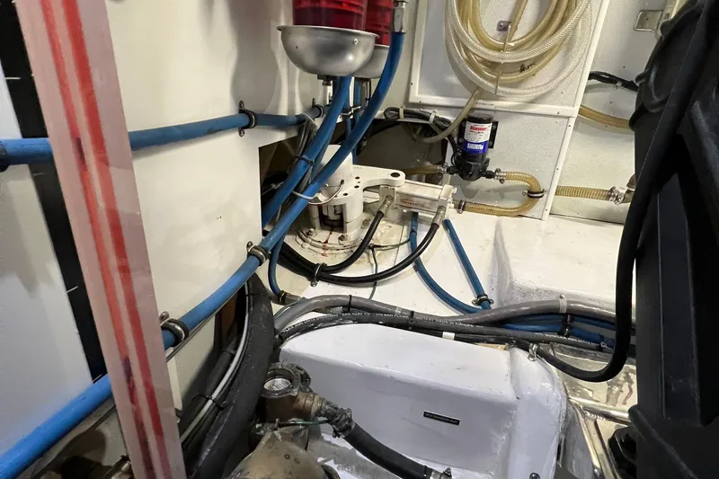 Slide: The Image of Engine room of a 2012 Hampton motor yacht with visible hoses and machinery. - 48