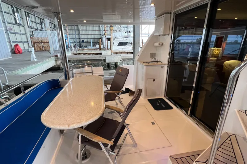 Slide: The Image of Luxurious 2012 Hampton motor yacht interior with dining area and modern amenities. - 6