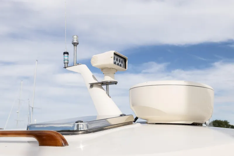 Slide: The Image of Wooden emblem from a 1999 Hinckley Picnic Boat 36 Classic, featuring a unique curved design. - 16