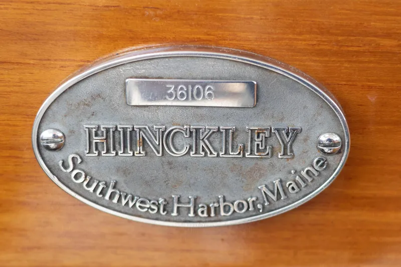 Slide: The Image of Hinckley Picnic Boat 36 Classic 1999 docked with fender, wooden deck visible. - 17