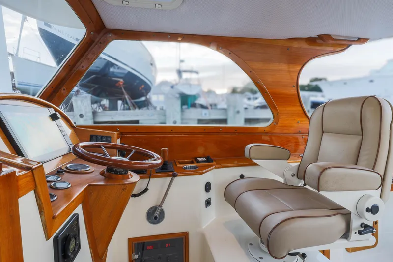 Slide: The Image of Interior of 1999 Hinckley Picnic Boat 36 Classic with wooden helm and leather captain's chair. - 2