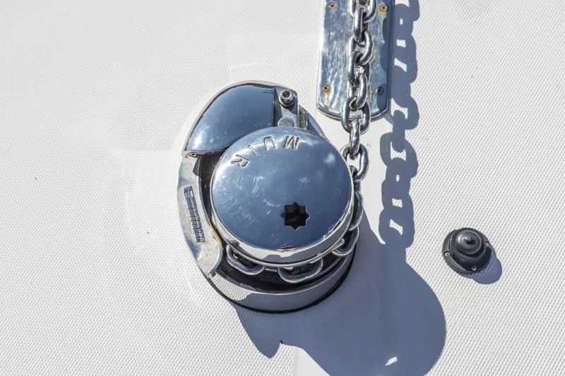 Slide: The Image of 1999 Hinckley Picnic Boat 36 Classic in a workshop, showcasing its sleek hull design. - 20