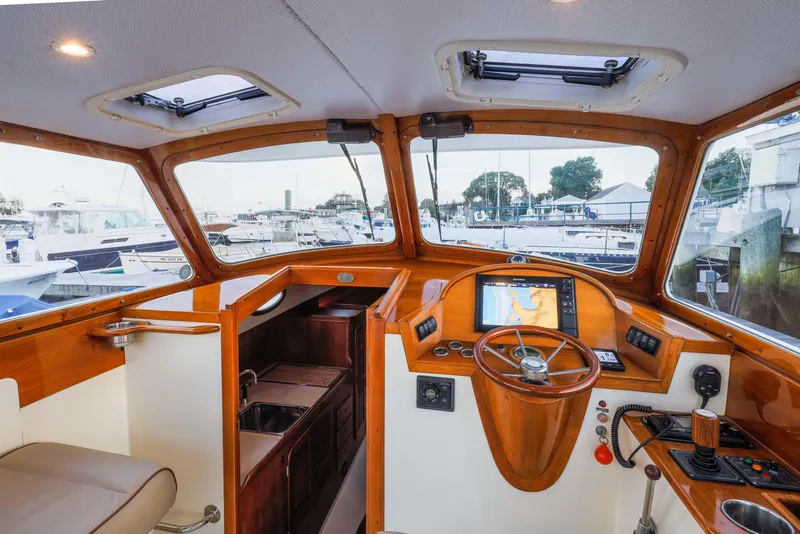 Slide: The Image of 1999 Hinckley Picnic Boat 36 Classic on clear water under blue sky. - 5