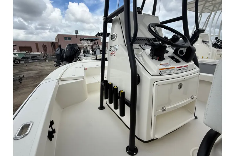 Slide: The Image of 2026 Pathfinder 2300 HPS boat interior with steering console, rod holders, and storage. - 10