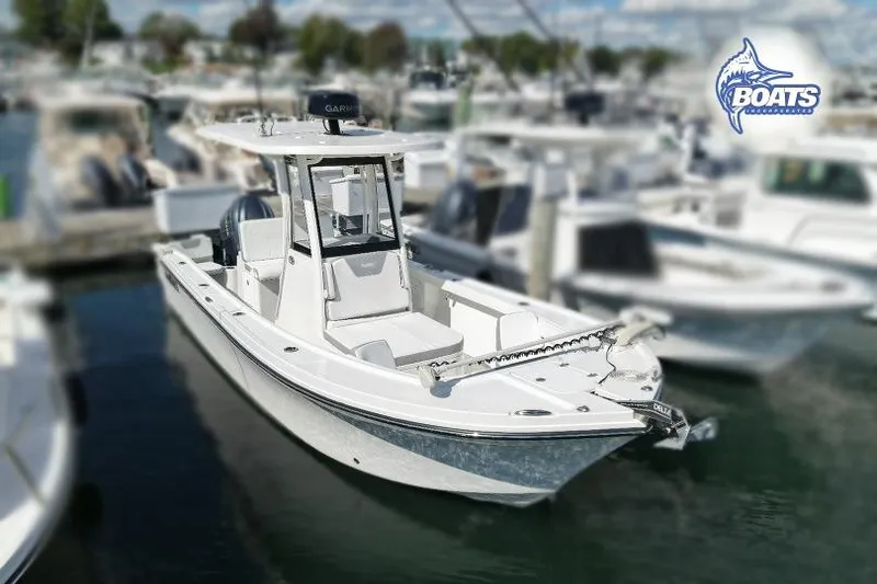 Slide: The Image of 2023 Parker 2400 Center Console boat docked in marina, featuring sleek design and modern equipment. - 0
