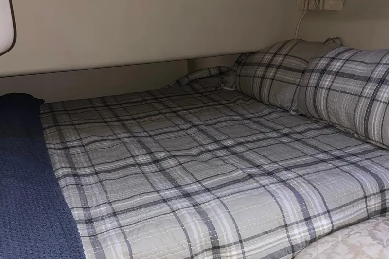 Slide: The Image of Cozy cabin bed with plaid bedding in 2000 Sea Ray 400 Sedan Bridge yacht. - 18