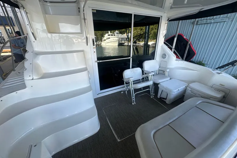 Slide: The Image of 2000 Sea Ray 400 Sedan Bridge yacht docked at marina under cloudy sky. - 3