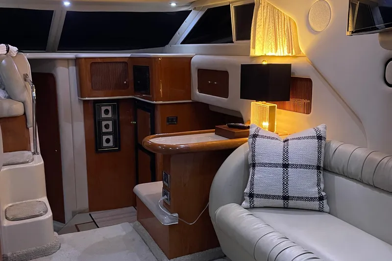 Slide: The Image of Luxurious interior of 2000 Sea Ray 400 Sedan Bridge yacht with plush seating and panoramic windows. - 4