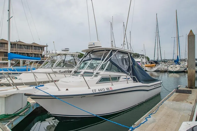 Slide: The Image of 1990 Grady White SEAFARER boat docked at marina with other vessels. - 1