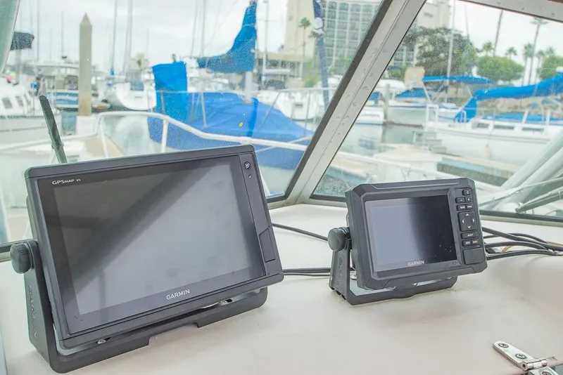 Slide: The Image of Garmin GPS devices on 1990 Grady White SEAFARER boat dashboard at marina. - 10