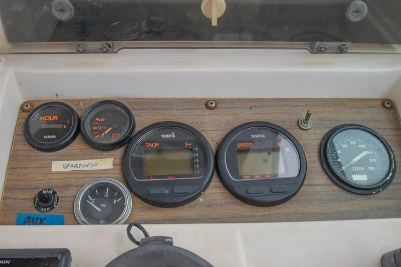 Slide: The Image of Dashboard of a 1990 Grady White SEAFARER boat with Yamaha gauges and controls. - 13