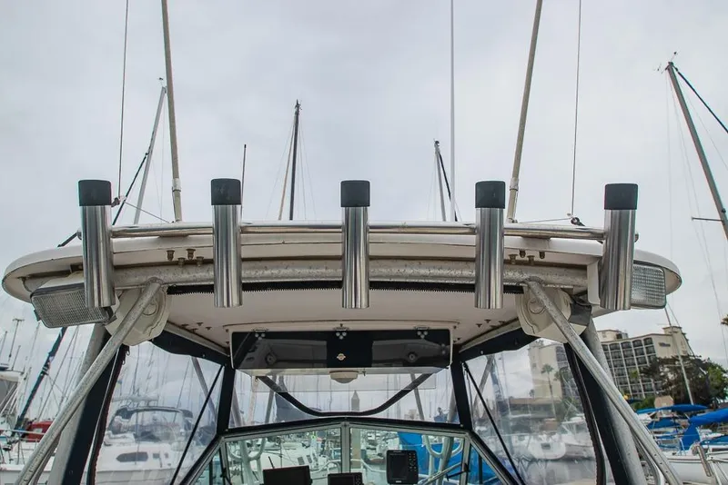 Slide: The Image of 1990 Grady White SEAFARER boat with rod holders, docked in a marina. - 17