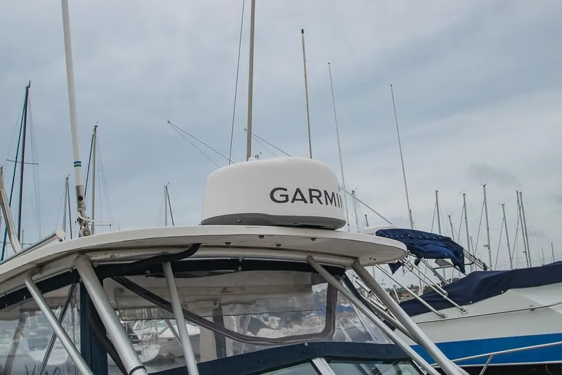 Slide: The Image of 1990 Grady White SEAFARER boat with Garmin radar, docked in marina. - 18