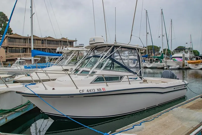 Slide: The Image of 1990 Grady White SEAFARER boat docked in marina, surrounded by other vessels. - 2