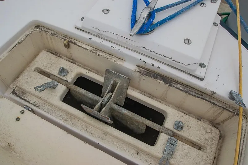 Slide: The Image of 1990 Grady White SEAFARER boat anchor compartment with blue rope and metal fittings. - 20