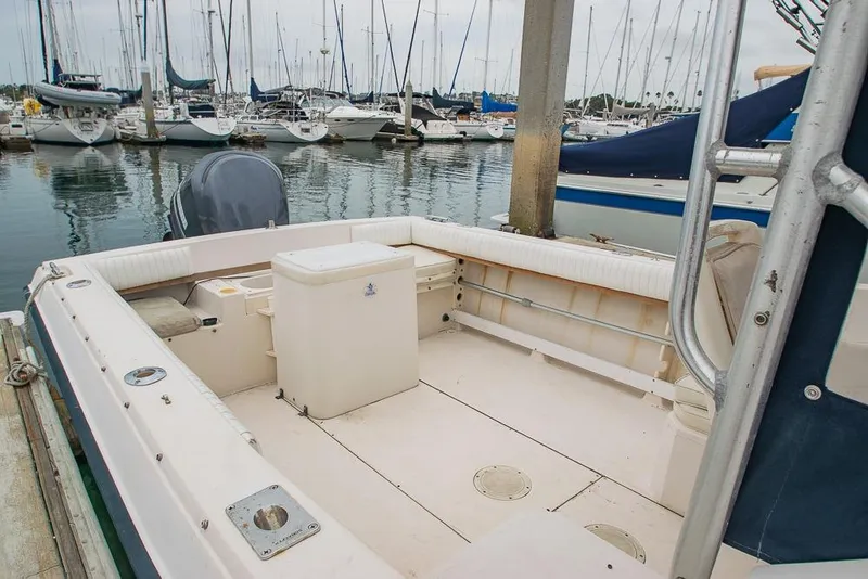 Slide: The Image of 1990 Grady White SEAFARER boat interior at marina, surrounded by sailboats. - 6