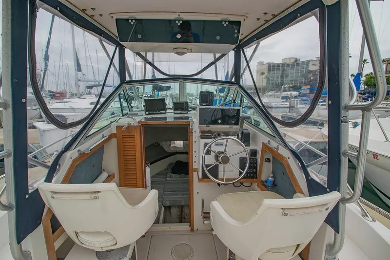 Slide: The Image of 1990 Grady White SEAFARER boat interior with helm, seats, and cabin view. - 8