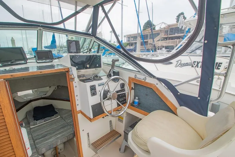Slide: The Image of 1990 Grady White SEAFARER boat interior with helm, seating, and navigation equipment. - 9