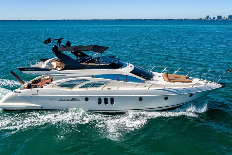 Slide: The Image of 2007 Azimut Fly 62 yacht cruising on open sea under clear blue sky. - 1