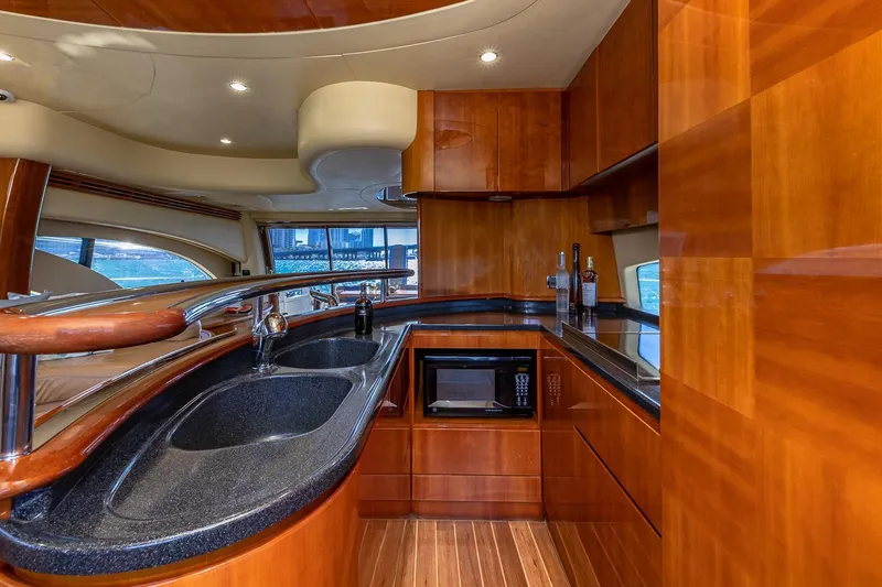 Slide: The Image of Luxurious 2007 Azimut Fly 62 yacht interior with sleek kitchen design and wooden cabinetry. - 18