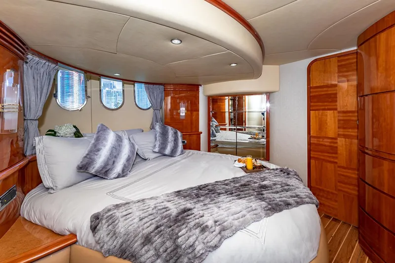 Slide: The Image of Luxurious bedroom interior of 2007 Azimut Fly 62 yacht with plush bedding and elegant wood finishes. - 19
