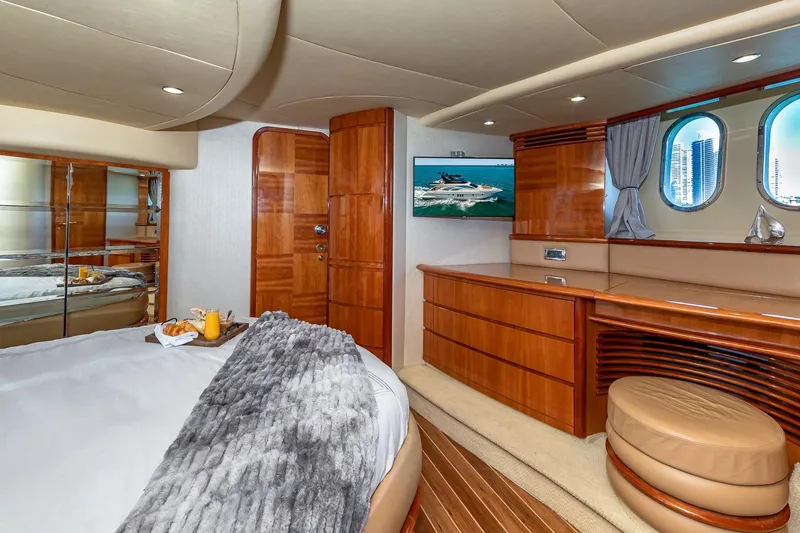Slide: The Image of Luxurious 2007 Azimut Fly 62 yacht bedroom with elegant wood finishes and cozy decor. - 20