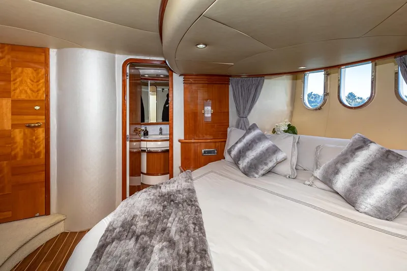 Slide: The Image of Luxurious 2007 Azimut Fly 62 yacht bedroom with elegant wood finishes and plush bedding. - 22