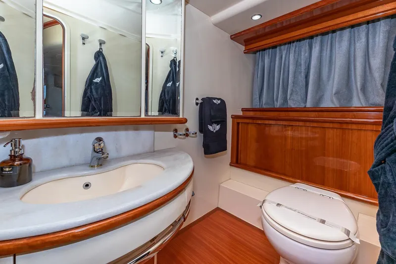 Slide: The Image of Luxurious bathroom in 2007 Azimut Fly 62 yacht with elegant fixtures and wood accents. - 23