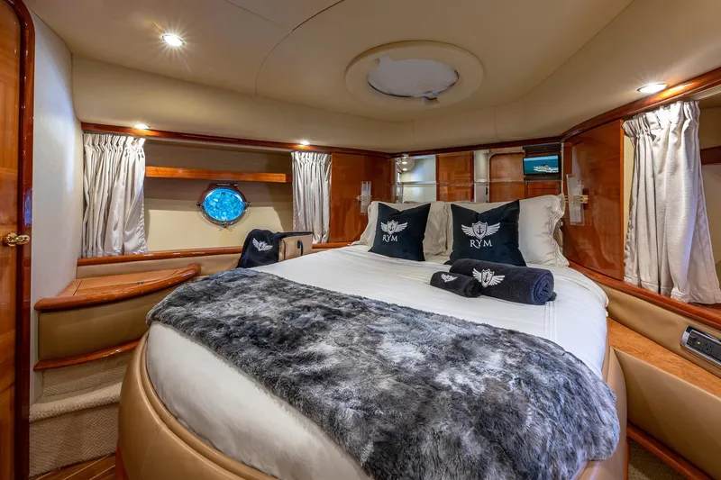 Slide: The Image of Luxurious bedroom interior of 2007 Azimut Fly 62 yacht with elegant bedding and wood accents. - 24